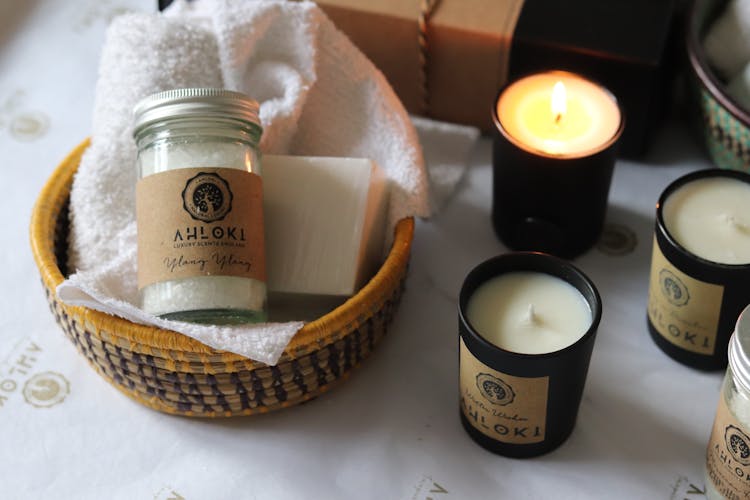 Jar And Towel In Basket Near Wax Candles