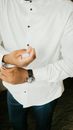 Unrecognizable groom in white shirt