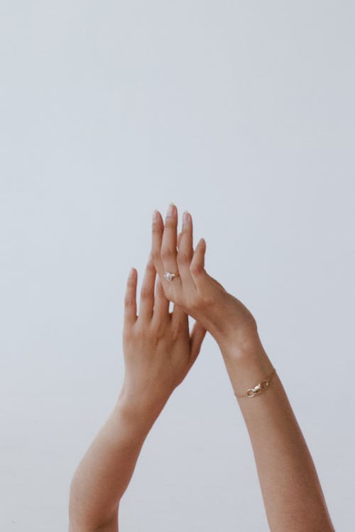 Person Wearing Gold Bracelet and Gold Ring