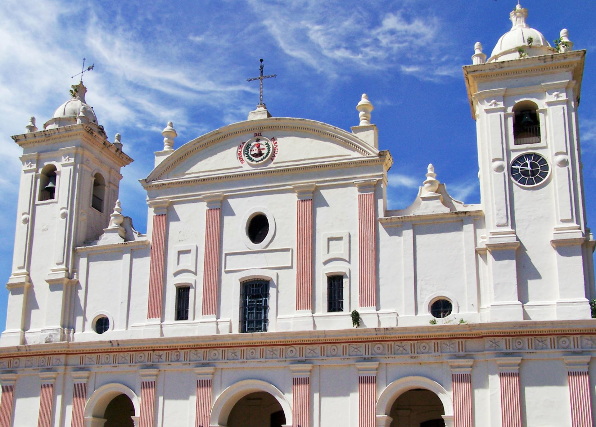 Front view of historic cathedral in Asunción, Paraguay with clear blue sky.