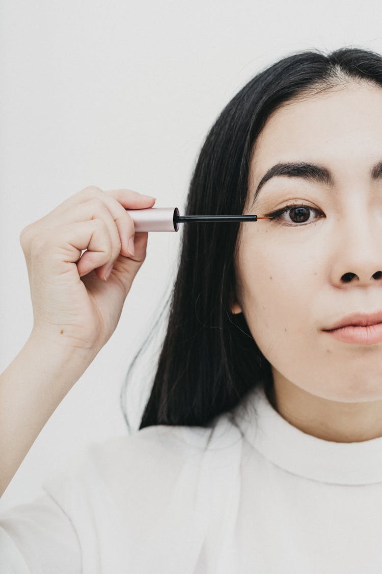 Woman Applying An Eyelash Serum 