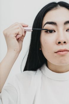 Woman in White Crew Neck Shirt Holding Pen