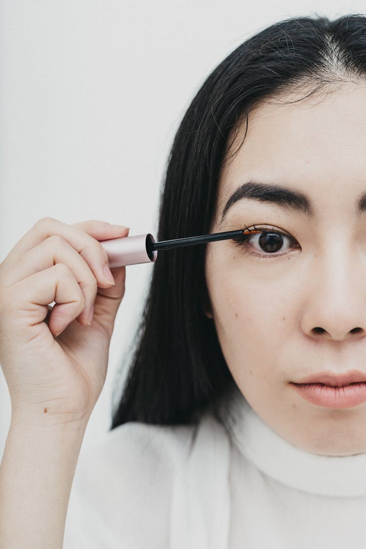 Woman Applying An Eyelash Serum 