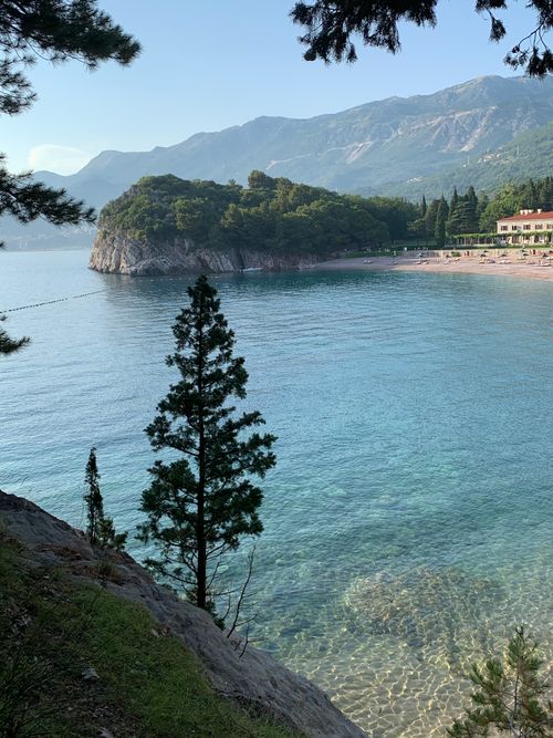 Free Explore the serene coastal landscape around Queen's Beach in Budva, Montenegro, captured with crystal clear waters and lush greenery. Stock Photo