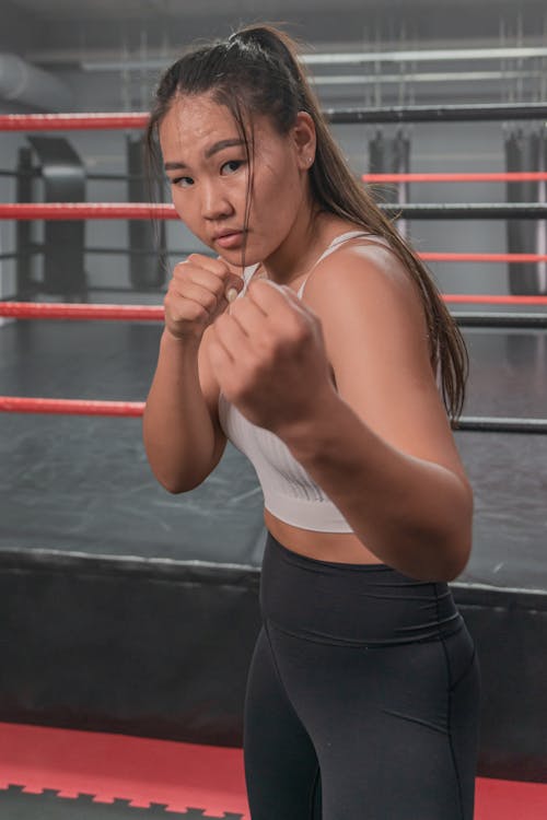 Free Woman in Sports Wear Ready to Fight Stock Photo
