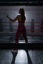Woman in Red Sports Wear Standing on Boxing Ring Ready to Fight