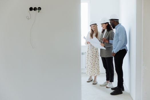 Architects reviewing plans in an unfinished room, photo by Thirdman on Pexels