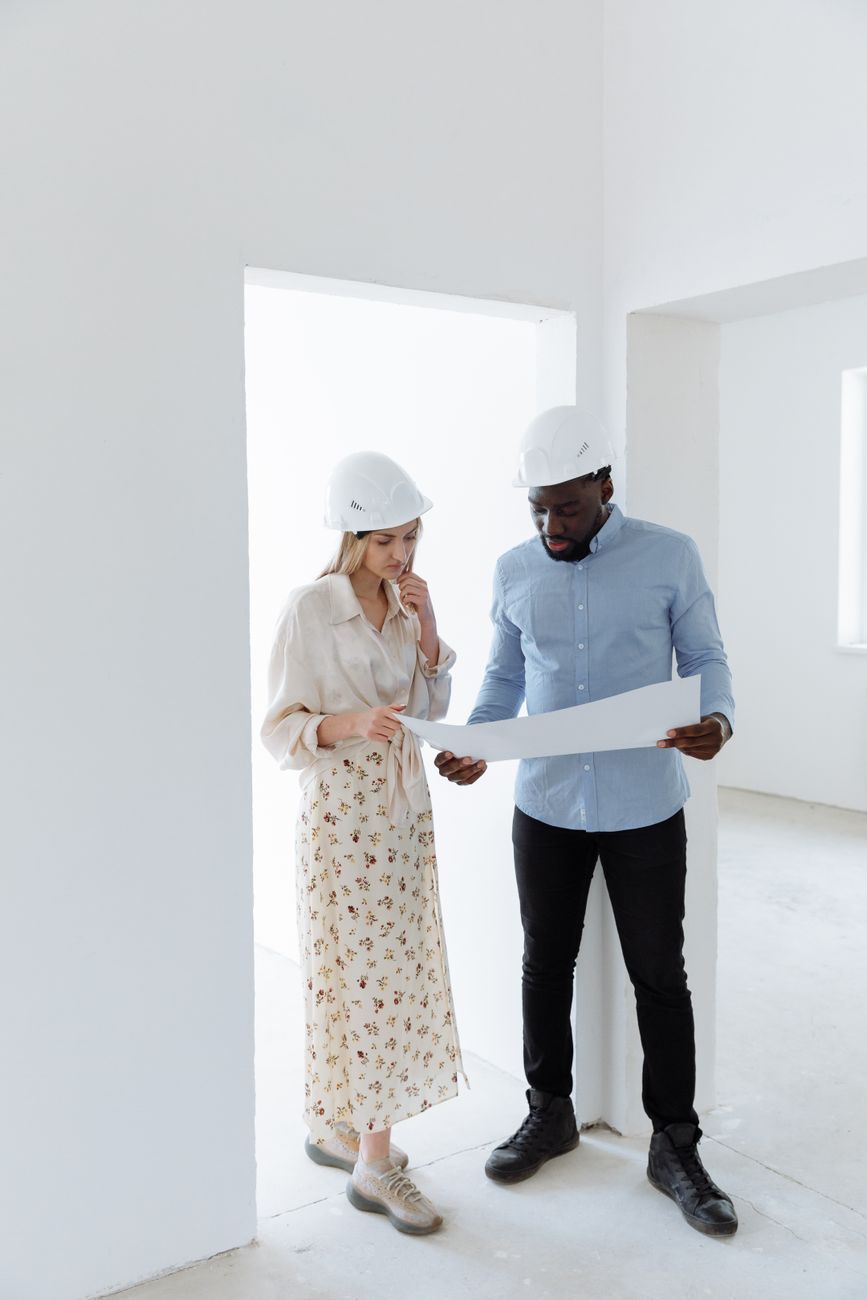 Construction professionals reviewing blueprints together