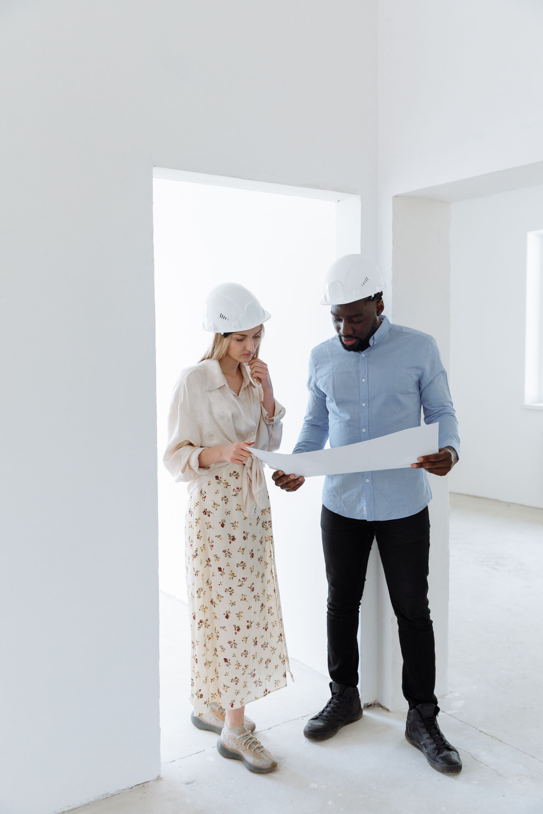 Professionals reviewing construction plans during pre-construction planning