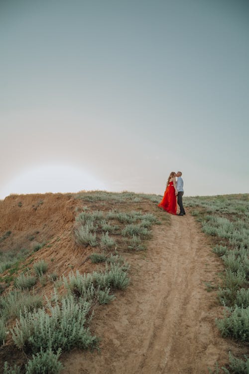 A Couple Kissing on an Unpaved Pathway