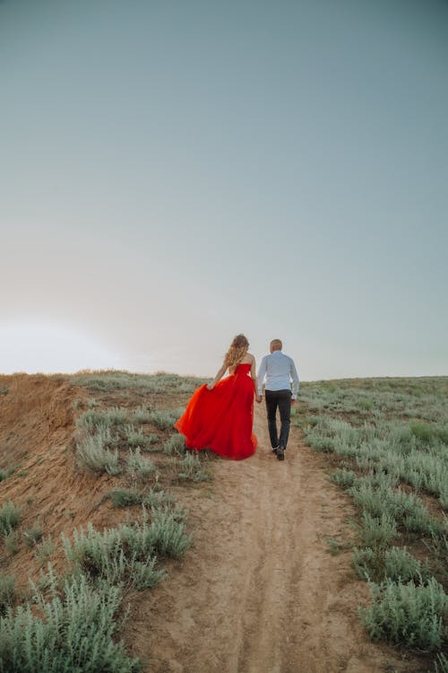 A Couple Walking on an Unpaved Pathway