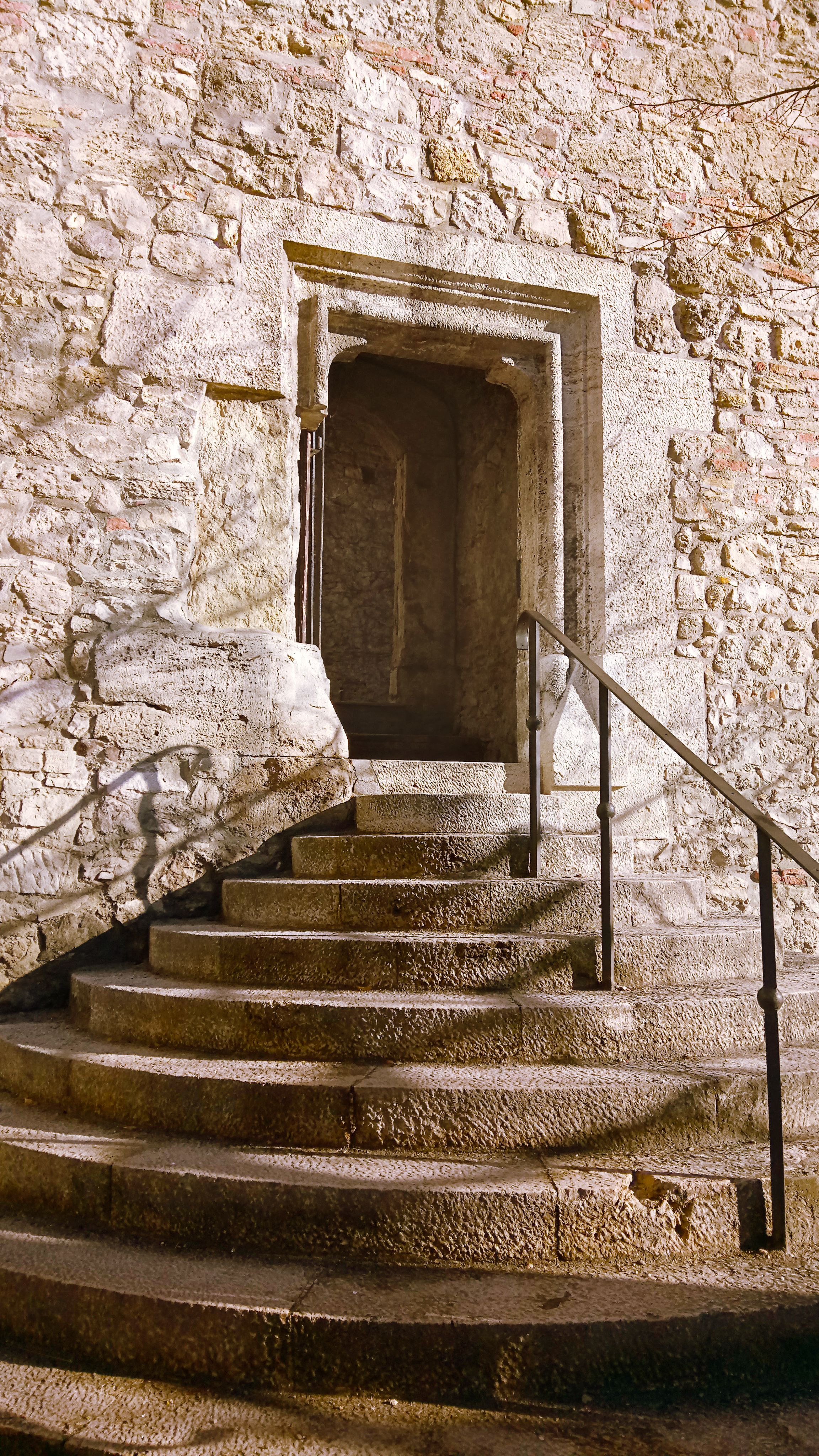Gray poured-concrete staircase with clean risers and a metal handrail