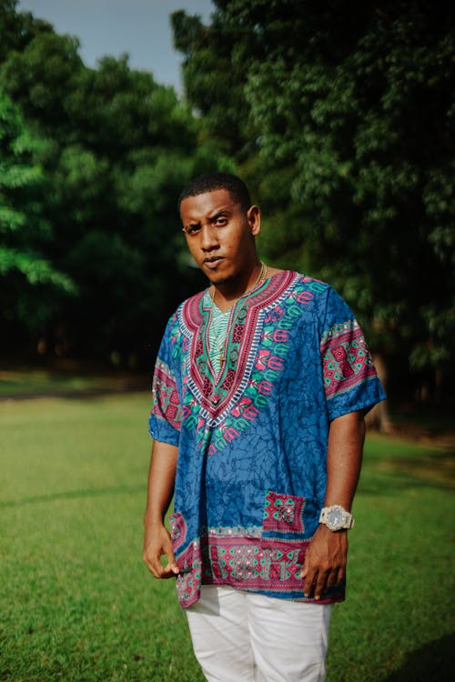 A Man in Printed Shirt Standing on the Field