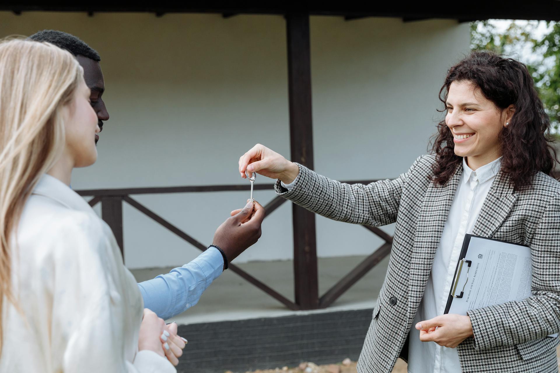 An Agent Handing the Key to the Owners