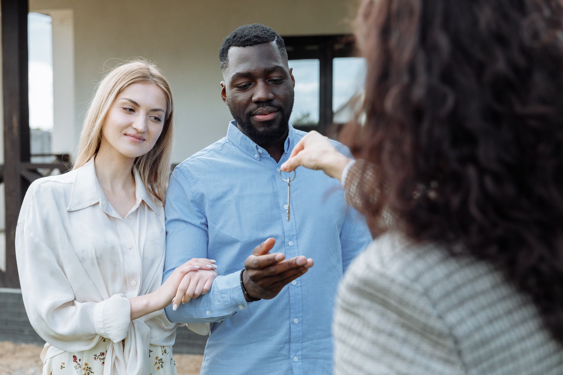 A couple receiving the keys to their new home from their agent