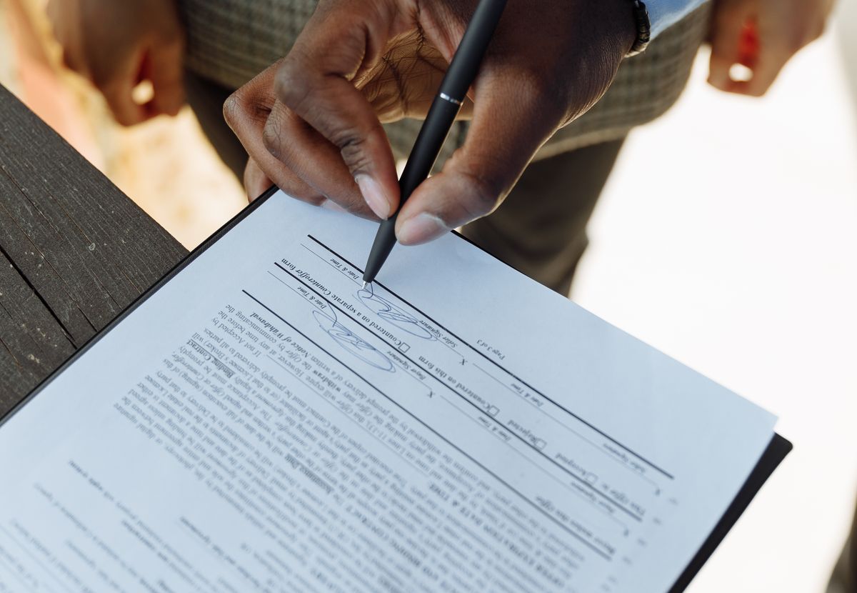 Customer completing and signing transaction paperwork