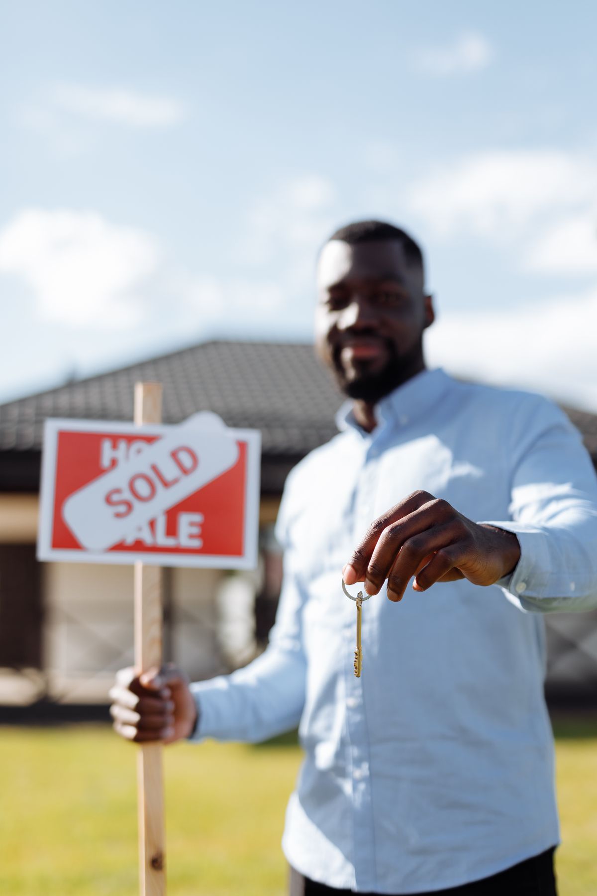 Black real estate professional holding keys