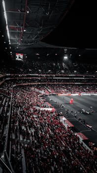 Atmospheric view of a football match at Estádio da Luz in Lisbon under stadium lights.