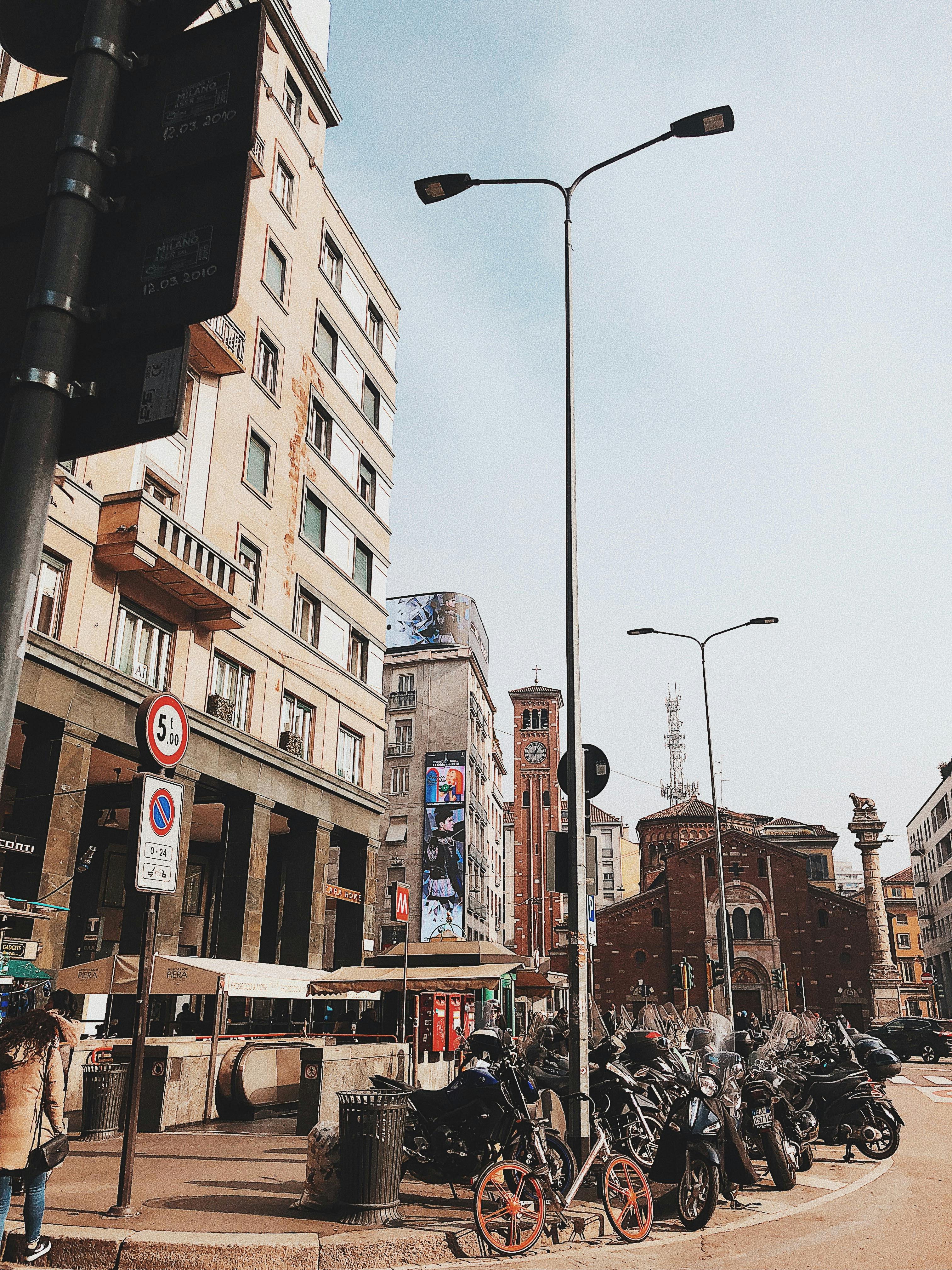 motorcycles parked in front of a building near a road