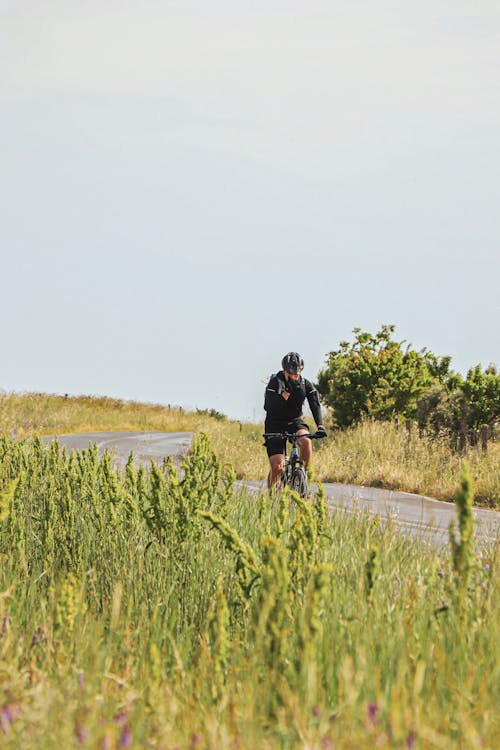 Man Riding a Mountain Bike on the Road