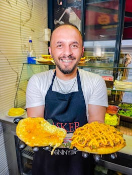A smiling chef presenting Turkish street food, showcasing vibrant flavors.