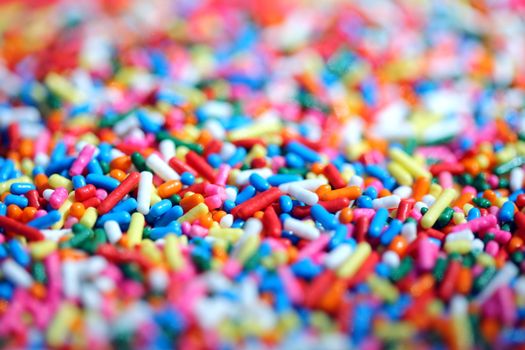 Colorful macro image of rainbow sprinkles used for decorating desserts.