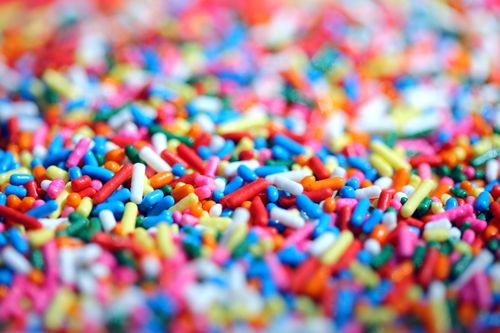Free Colorful macro image of rainbow sprinkles used for decorating desserts. Stock Photo