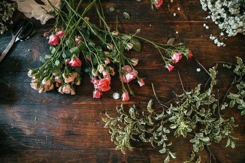Free Overhead Shot of Flowers on a Wooden Surface Stock Photo