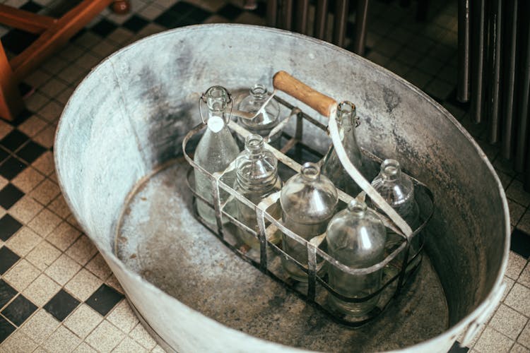 Glass Bottles On A Metal Basin