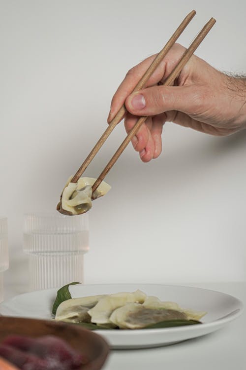 A Person Holding Chopsticks