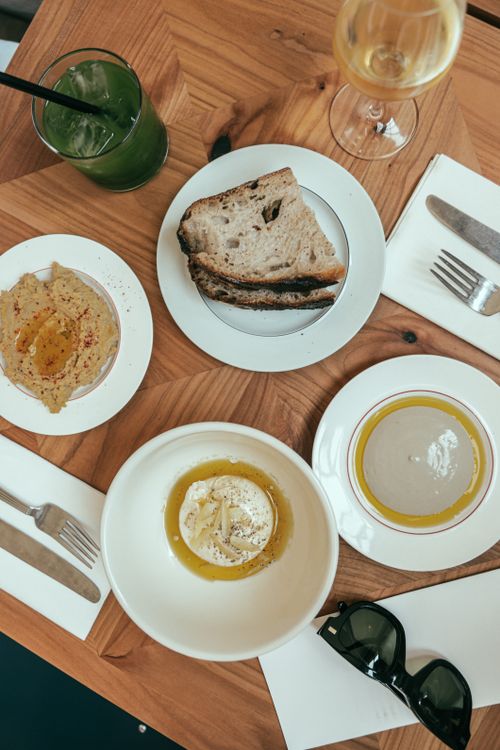 Free Flat lay of artisanal bread and Mediterranean dips, perfect for a cozy meal. Stock Photo
