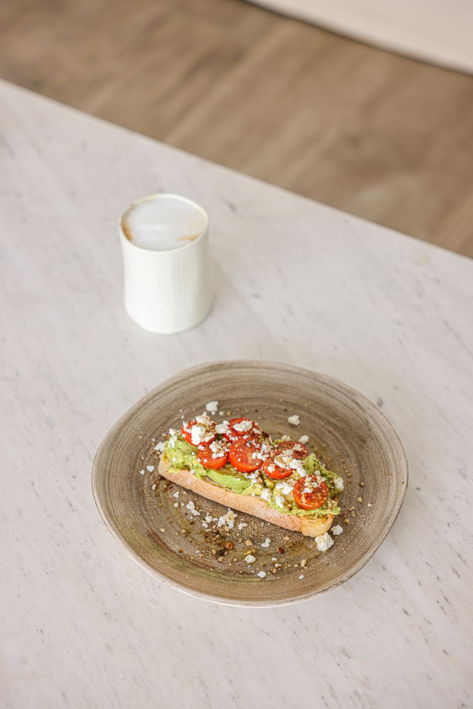 Avocado toast with cherry tomatoes on a ceramic plate