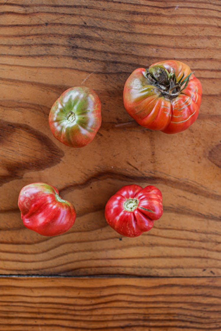 Heirloom Tomatoes On A Wooden Surface