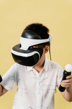 Young boy engaged in virtual reality gaming with VR headset and controllers.