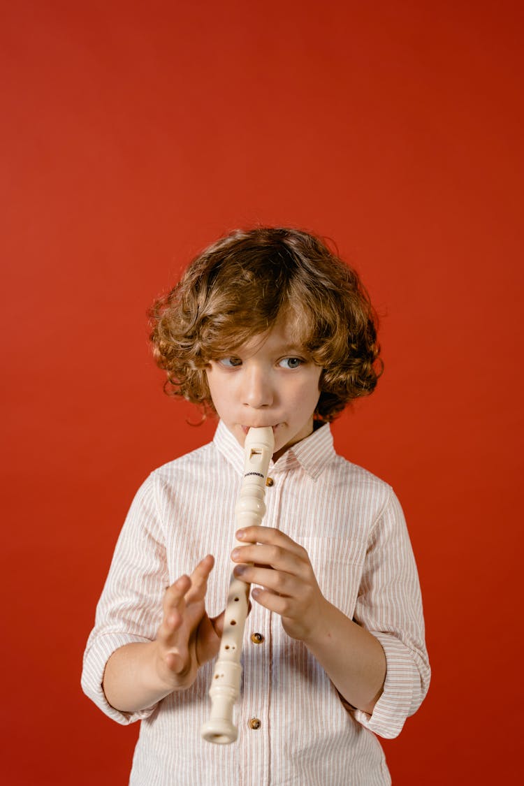 A Boy Playing The Flute