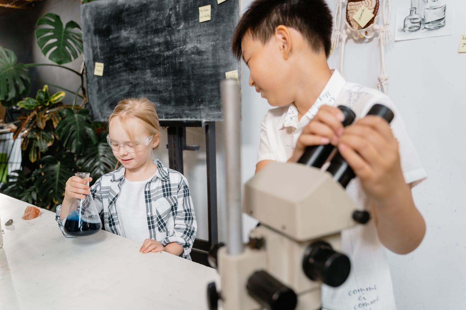 Children performing a science experiment with a microscope