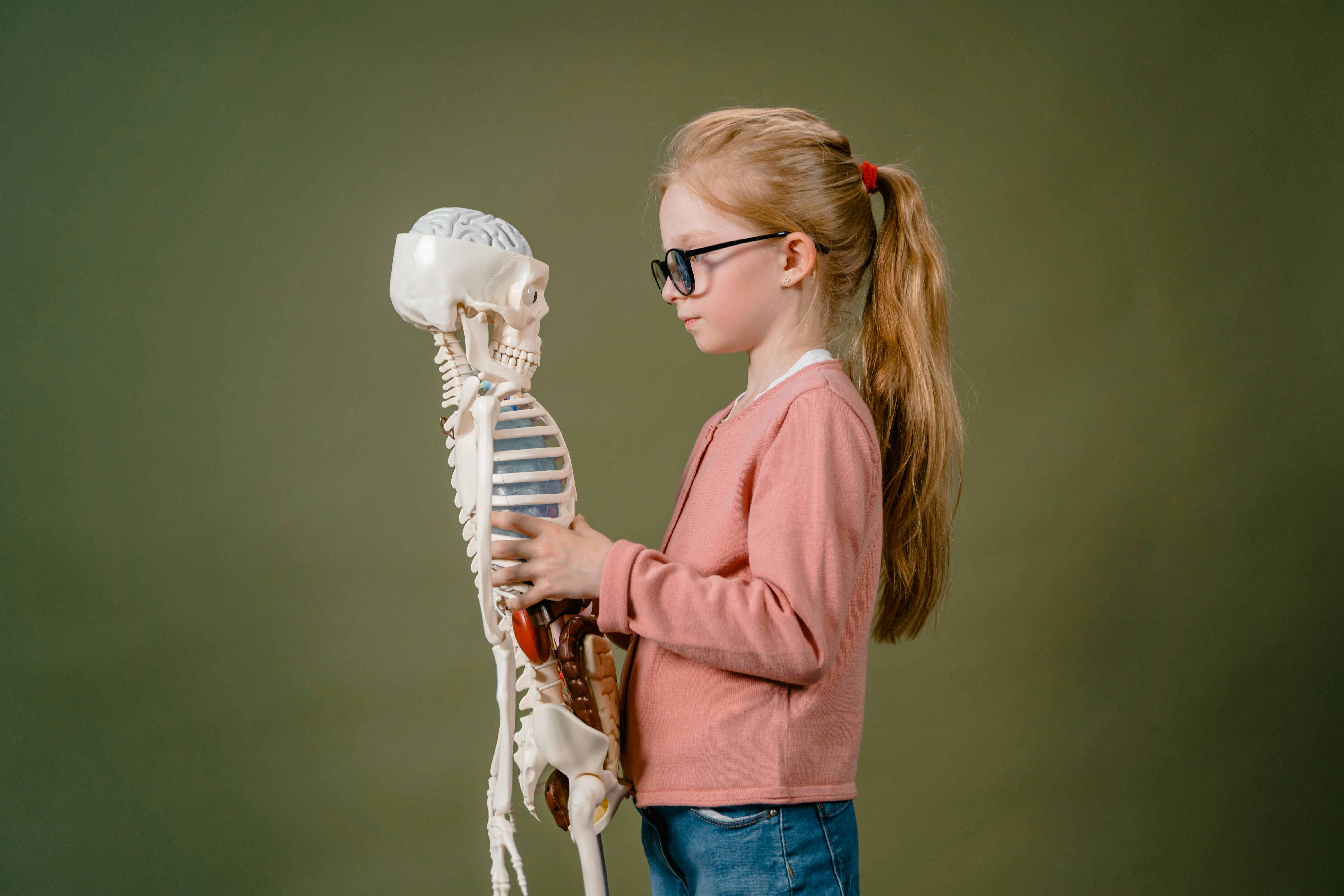 a girl holding a skeleton