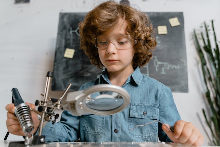 Close-Up Photo Of A Smart Boy Doing A Science Experiment