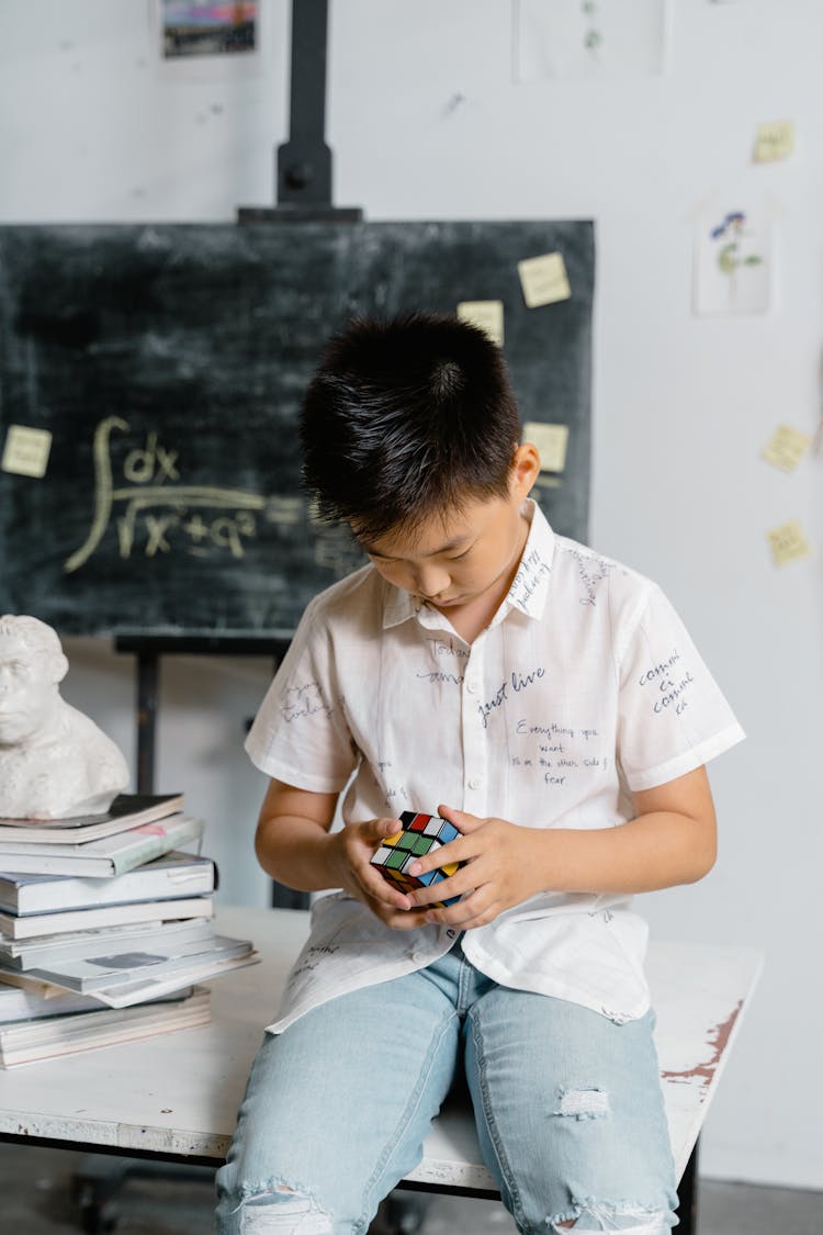 A Boy Solving A Rubik's Cube