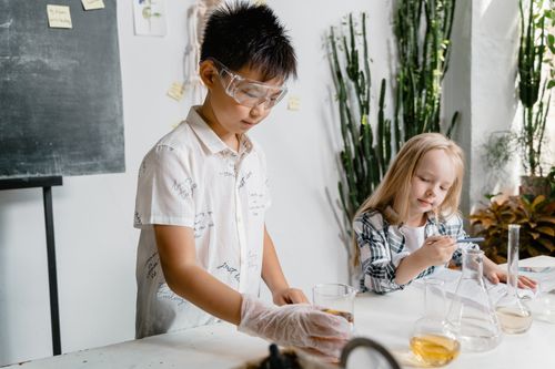 Free Curious kids conducting a hands-on science experiment with lab equipment. Stock Photo