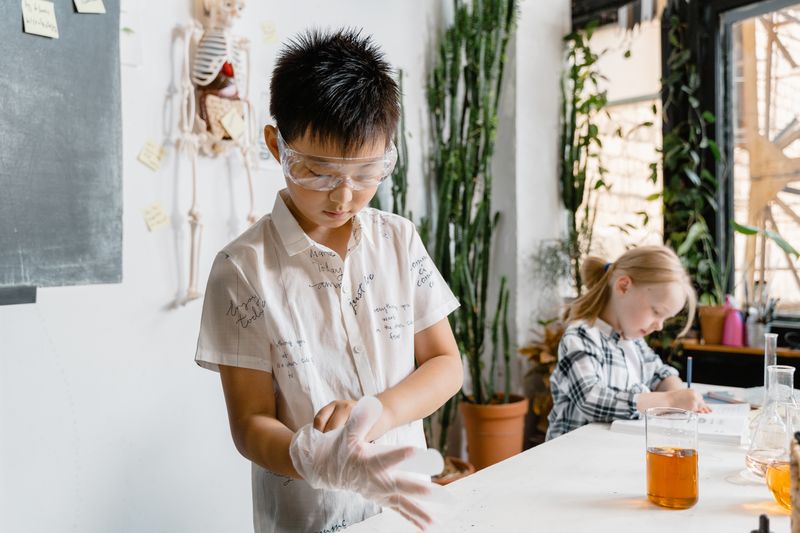 Children engaging in a hands-on science experiment with laboratory equipment indoors.