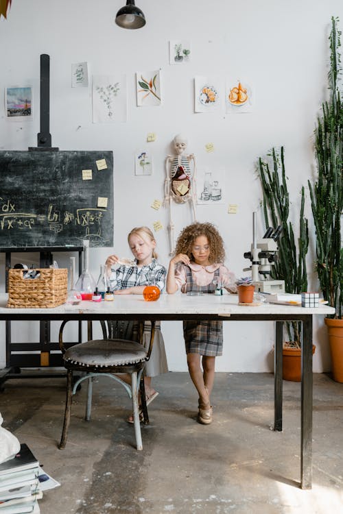 Two Girls Doing a Science Experiment Inside the Laboratory