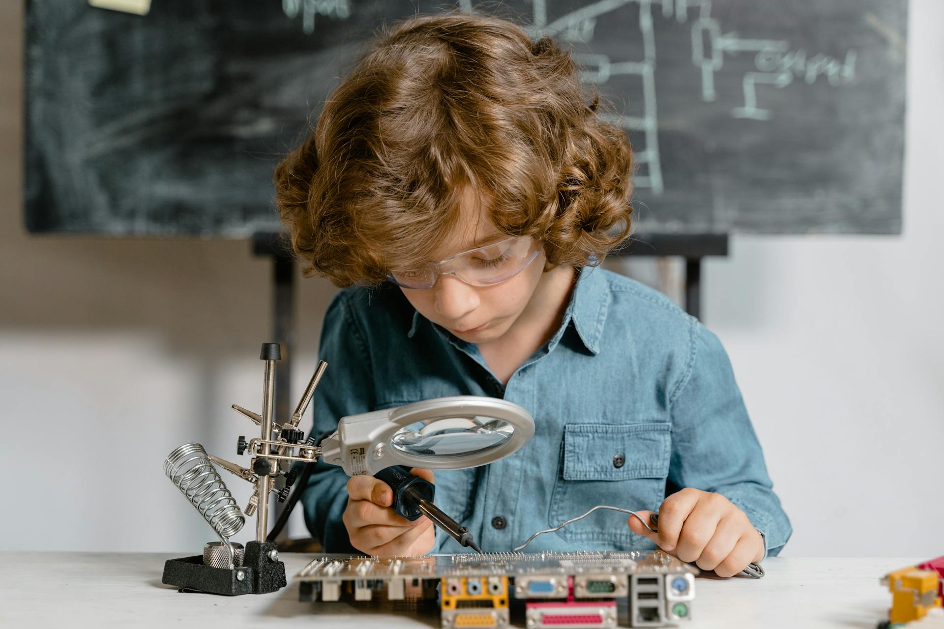 Close-Up Photo of a Smart Boy Doing a Science Experiment