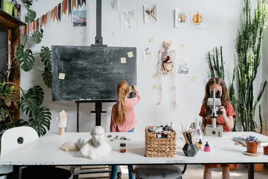 Young girls exploring science with a microscope in an interactive classroom setting.