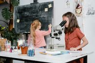 A Smart Girl Using a Microscope