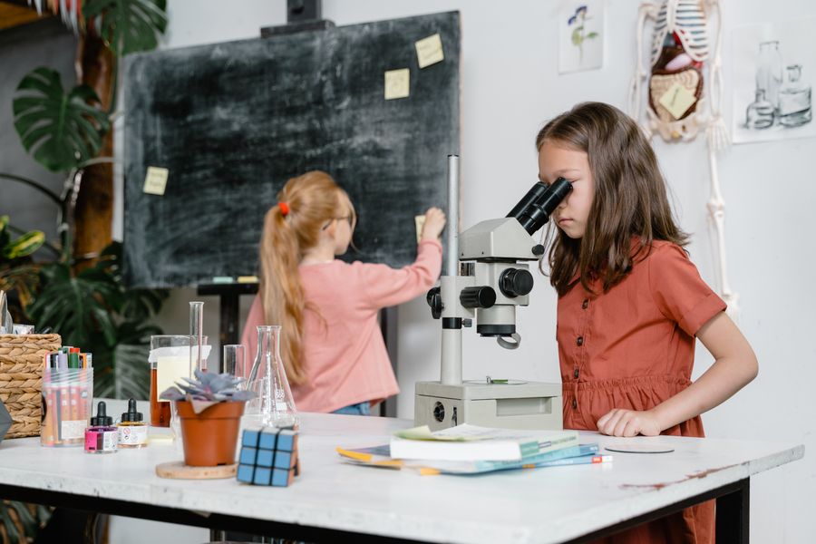 Two students using a microscope during a biology practical