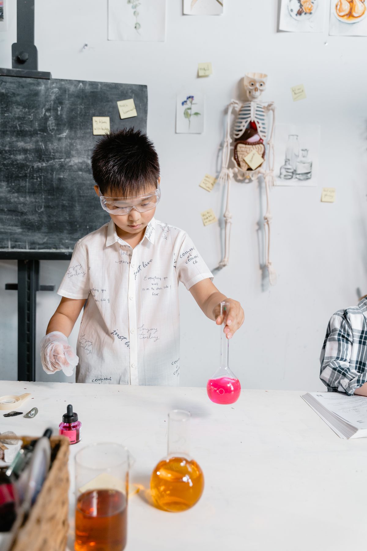 Child doing a science experiment with laboratory equipment