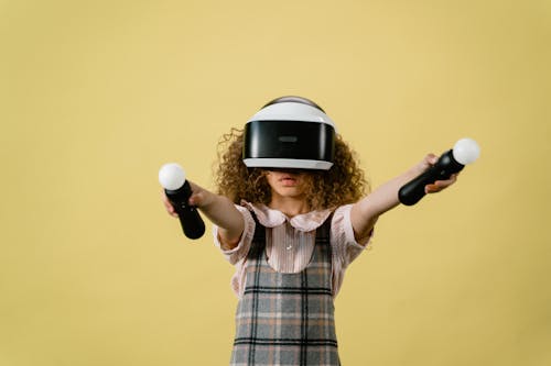 A Girl Playing in a Virtual Reality on Yellow Background