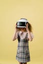 A Girl Playing in a Virtual Reality on Yellow Background