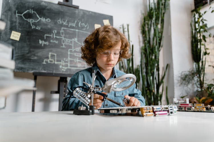 Close-Up Photo Of A Smart Boy Doing A Science Experiment